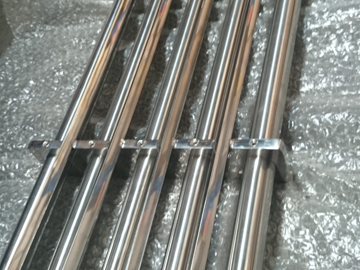 Full-length view of a stainless steel grate magnet with parallel large-diameter magnetic bars