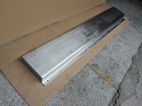 Full-weld stainless plate magnet on a workshop floor
